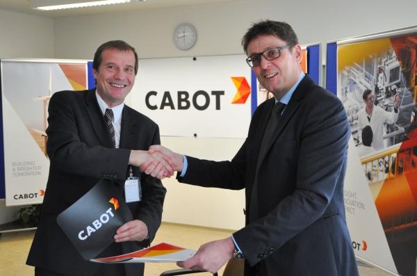 Oberbürgermeister Klaus Eberhardt (links) und Werksleiter Andreas Cendra vor dem neuen Logo der Cabot Corporation 